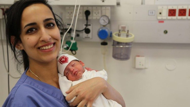 A nurse and newborn baby at the Hospital of the Holy Family in Bethlehem