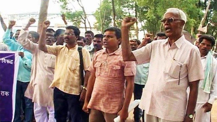 Fr. Stan Swamy SJ (right) at a protest by indigenous people. 