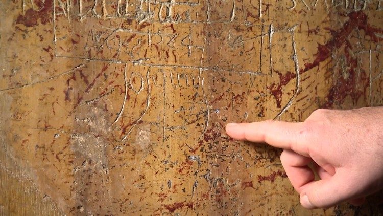 Maestro Marcos Pavan points out Josquin's probable signature in the graffiti found in the choir loft of the Sistine Chapel