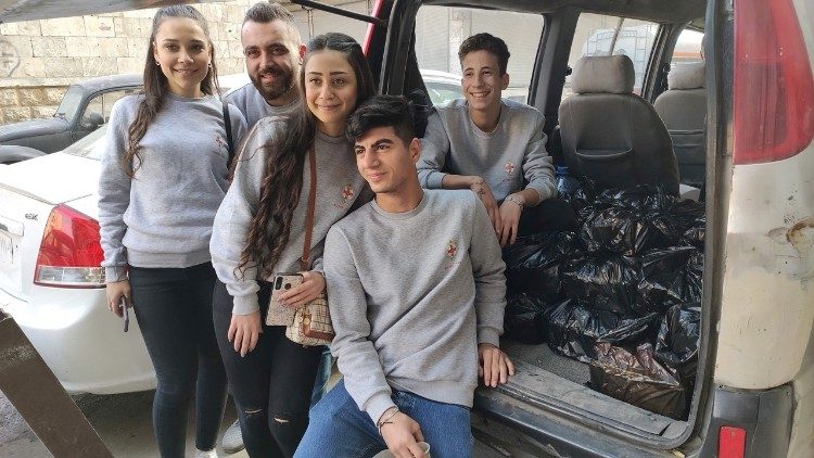 Young volunteers distribute food packages in Aleppo, Syria