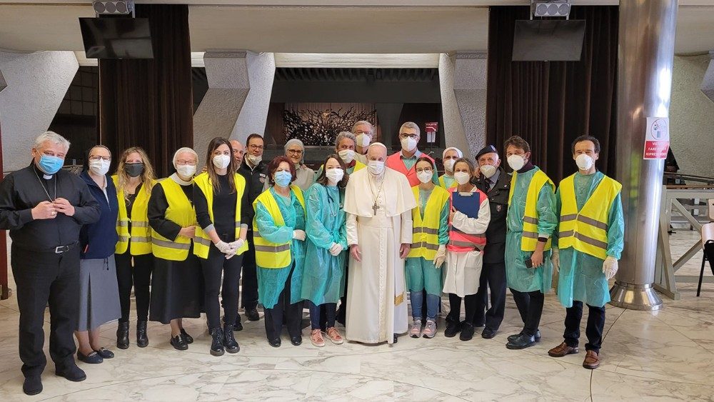 Pope Francis visits with volunteers, nurses and doctors assisting with vaccinations