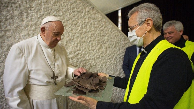 Pope Francis accepts a piece of chocolate