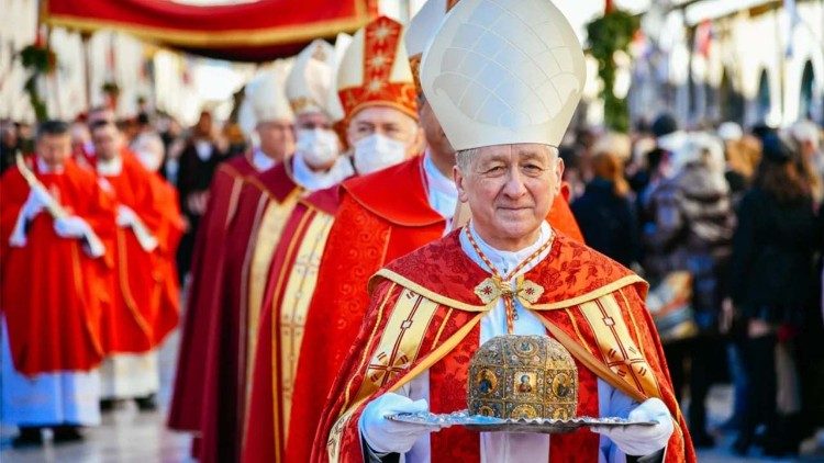 Cardinal Blase Cupich leads a procession with the relics of his namesake saint