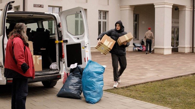 Students loading supplies into a van