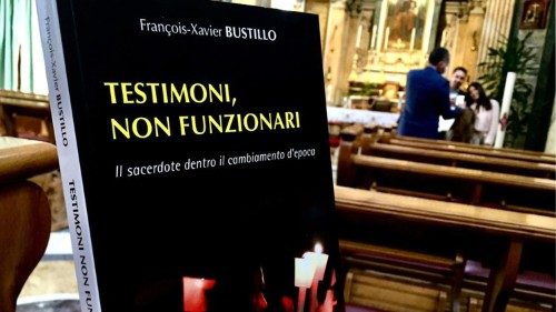 Pope Francis gives a book to priests present at Chrism Mass