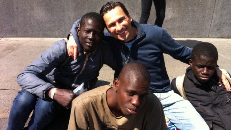Luca with several young migrants in Turin’s Castello Square