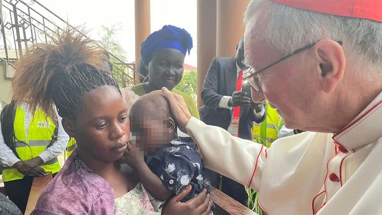 In South Sudan, Cardinal Parolin blesses almost two-year-old Nelson, a child who could go blind