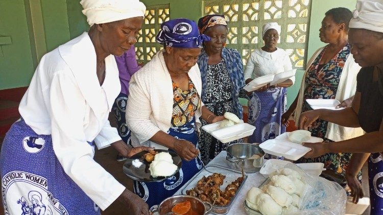 Some of the parish’s elderly helping themselves to the Zambian dish of Nsima or Buhobe at the Sunday celebration.