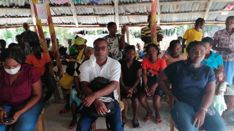 El padre Verna Cineus (al centro)  se reúne con el pueblo de Haití