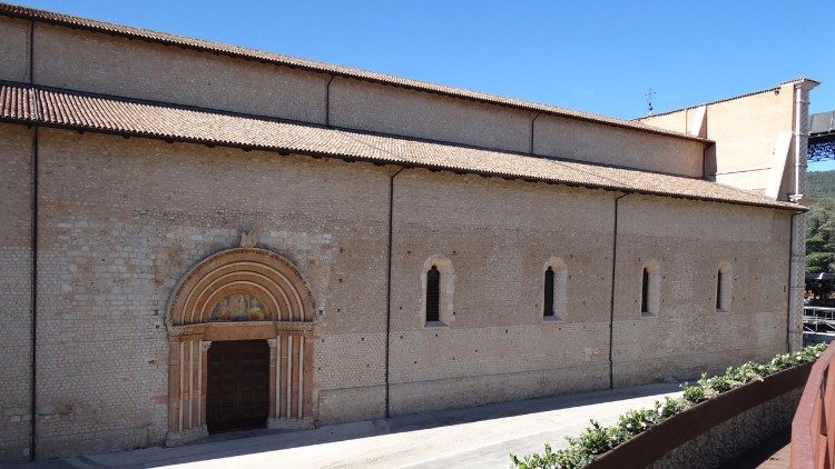 La facciata sinistra della Basilica di Collemaggio con la Porta Santa che viene aperta per la Perdonanza