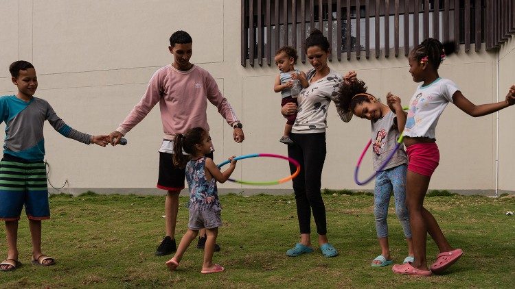 Enzor Figuera, ein venezolanischer Migrant, spielt mit seinen Kindern, während er auf eine Ausbildung und einen festen Arbeitsplatz wartet. (@Margherita Mirabella/Archivio GSF)