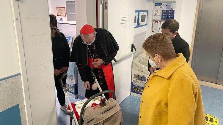 El Cardenal Parolin bendice a una recién nacida.