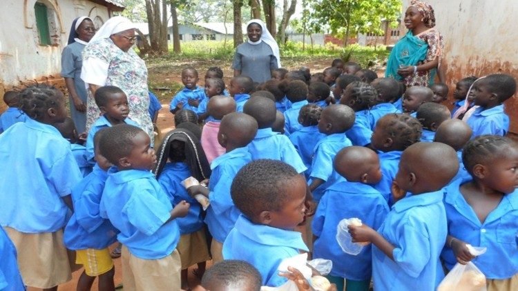 Sr Alphonsa Kiven and her sisters surrounded by children, Bishop's compound, Berbrati, Central Africa, 2015