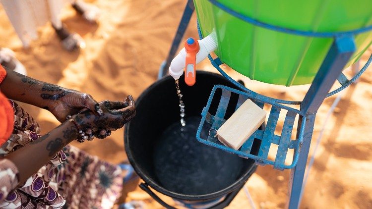 Uma estação de lavagem de mãos em frente à escola Hanti Goussou, em Niamey, no Níger, usada no primeiro dia de aula após meses de fechamento da escola.