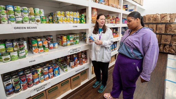 Sister Jennifer discusses the importance of making good food choices with a client (courtesy of Catholic Charities West Virginia)
