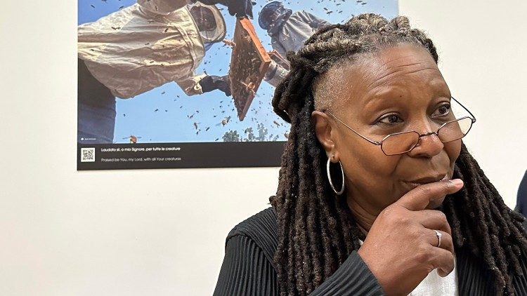 Whoopi Goldberg turns away after looking at a photo of beekeepers and their hive and suggests she send the MAP some bees